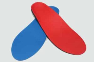 A blue and a red orthotic shoe insert