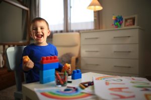 A happy child playing with blocks